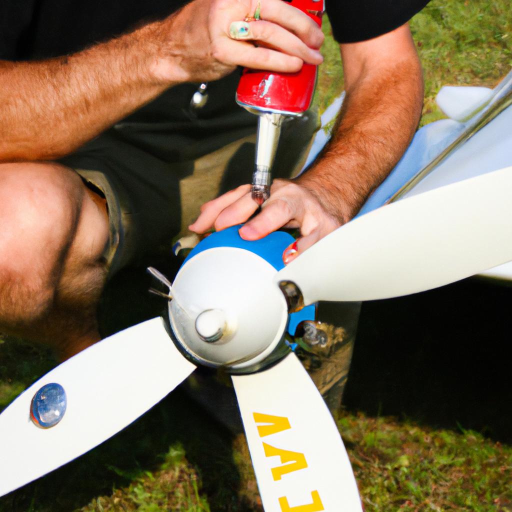Person cleaning RC plane propeller