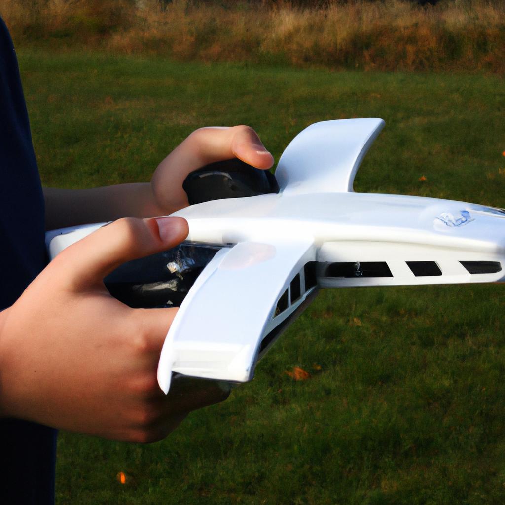 Person holding remote control aircraft